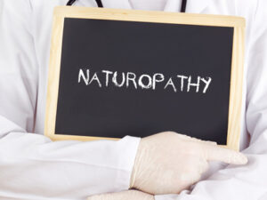 Doctor shows information on blackboard: naturopathy © gwolters